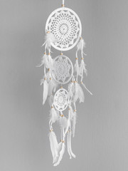 Wall Mural - White dreamcatcher at gray background. Interior decoration. Native American Dreamcatcher