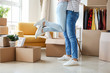 © Pixel-Shot - Young couple having fun while unpacking things in their new flat on moving day