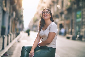 Poster - Young beautiful woman smiling happy and confident. Standing with smile on face at the town street