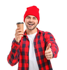 Canvas Print - Young man with cup of hot coffee showing thumb-up on white background