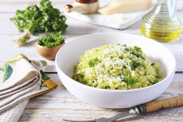 Italian cuisine. Parsley risotto, olive oil and Parmesan cheese