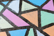 © Ciara - Brightly colored geometric shapes drawn in chalk along a side walk.