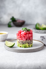 Wall Mural - Tuna tartare tartar with avocado and quinoa. gourmet presentation with culinary ring on wite plate