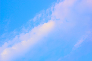 a photo of a cloud in the bright blue sky in the morning, looking very beautiful and charming.