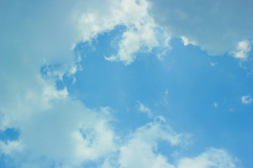 a photo of a cloud in the bright blue sky in the morning, looking very beautiful and charming.