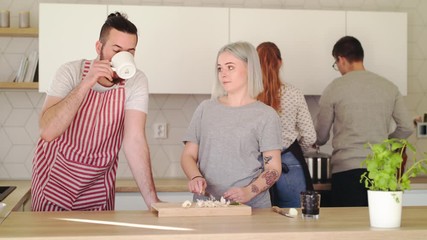 Wall Mural - Young people cooking together at home, house sharing concept.