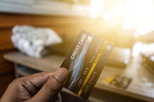 The Image Of A Person Holding A Blue Credit Card And Deciding To Spend Online With A Blurry Background And Orange Light Suitable For Use In Blending Content