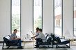 © DragonImages - Business partners meeting in lounge area to discuss project and contract details