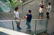 © DragonImages - Business people standing on stairs and discussing project they are working on together