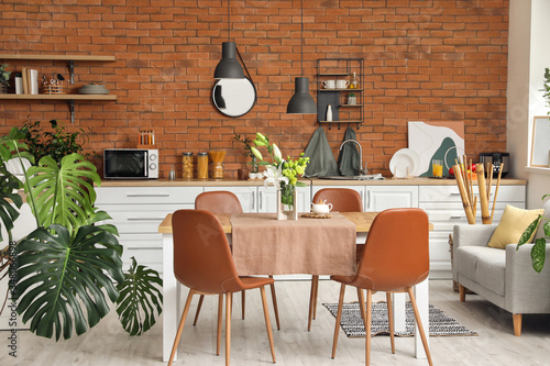 Fotografía Interior of modern stylish dining room with floral decor