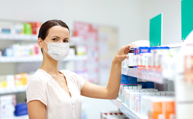 Sticker - medicine, healthcare and people concept - female customer in face protective medical mask for protection from virus disease choosing drugs at pharmacy