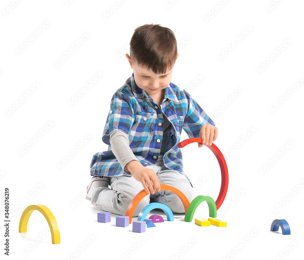 Little boy with toys on white background