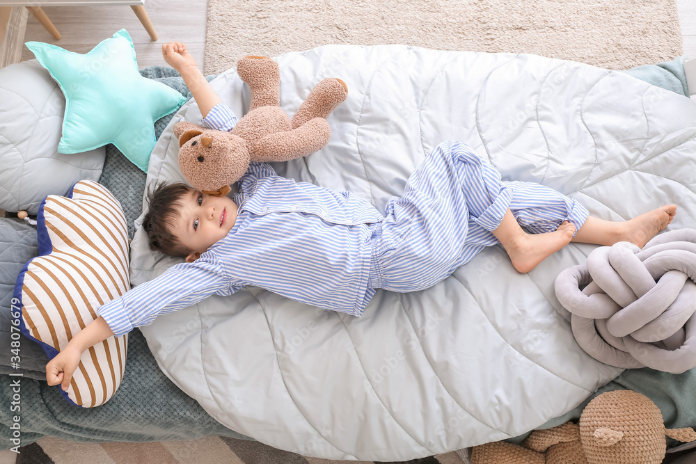 Little boy with teddy bear at home