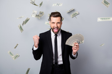 Poster - Ecstatic crazy man employee get debit salary millionaire lottery winner hold 100 hundred dollar fan money fly fall raise fists scream wear black blazer jacket isolated grey color background