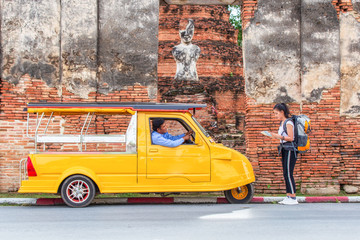 Wall Mural - Traveler japanese girl hollding map travel query for the way with old man driver taxi or tuk tuk touring.