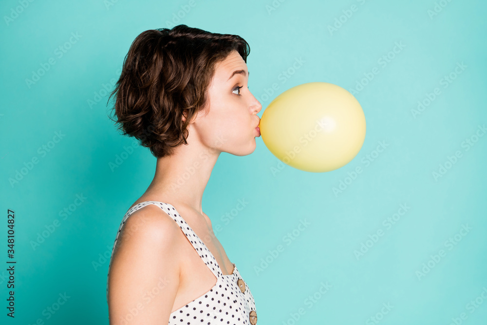 Profile photo of pretty lady big eyes holding big chewing gum inside mouth blowing large bubble wear casual white dotted overall isolated pastel teal color background - obrazy, fototapety, plakaty 
