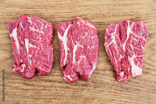 Raw beef steaks on wooden cutting board.. Copy space, top view. Canvas Print