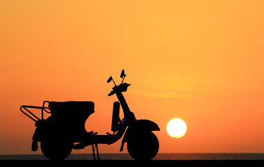 Wall Mural - silhouette classic motocycle on sunrise background