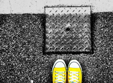 Yellow Canvas Shoes By Manhole Cover