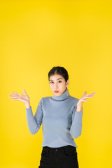 Photo of Advertising concept Asian women look good, positive thinking Are showing gestures. Happy, Surprise and success with yellow background and copy space.