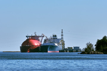 LNG tanker and carrier as floating LNG storage and import terminal in port. Alternative gas supply, commercial freight, energy crisis, diversification