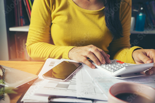 Fotomural Budget planning concept, Accountant calculating tax and using mobile phone, work online at home