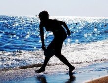 Silhouette Woman Walking At Beach