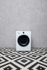 Wall Mural - modern washing machine near grey wall and ornamental carpet in bathroom