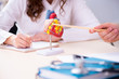 © Elnur - Young male doctor cardiologist and female student in the classro
