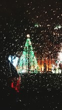 Illuminated Christmas Tree Seen Through Wet Window In Rainy Season