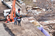 © Zhanna - Excavator working to get rid of the rubbish in a demolition site. Demolition of the old industrial building.