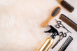 © 9dreamstudio - Hairdresser set in beauty salon. Combs, scissors, spray on beige desk top-down copy space