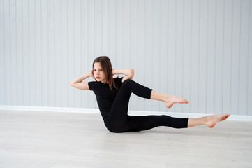 a teenage girl plays sports at home during quarantine in a bright room