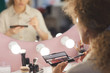 Back view close up of unrecognizable young woman holding eyeshadow palette while applying make up by vanity mirror, copy space