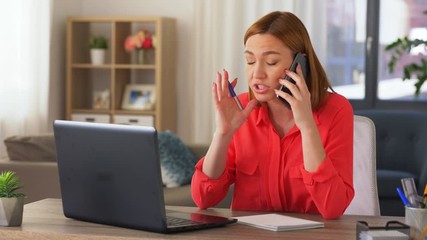 Wall Mural - remote job, technology and people concept - angry young woman with laptop computer calling on smartphone at home office