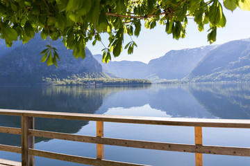 view of a lake from behind a wooden fence