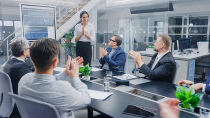 Wall Mural - In the Corporate Meeting Room: Female Executive Uses Digital Interactive Whiteboard for Presentation to a Board of Directors, Lawyers, Investors. Everyone Applauds. Screen Shows Company Growth Data