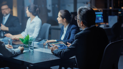 Late at Night In the Corporate Office Meeting Room: Executive Director Leads Hard Negotiations with Businesspeople. Over the Shoulder Back Shot 