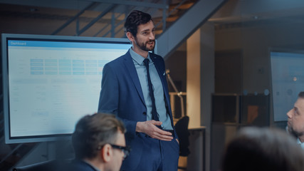 In Corporate Meeting Room: Energetic and Young Startup Creator Uses Digital Interactive Whiteboard for Presentation and Delivers Powerful Speech to a Board of Executives Investors and Businesspeople