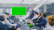 © Gorodenkoff - In the Corporate Meeting Room: Creative Director Uses Digital Chroma Key Interactive Whiteboard for Presentation to a Board of Executives, Lawyers, Investors. Green Mock-up Screen in Horizontal Mode