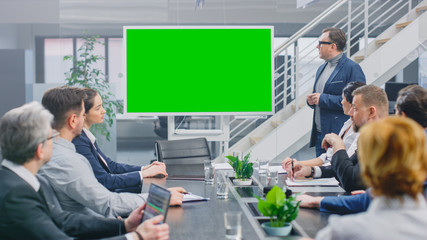 In the Corporate Meeting Room: Creative Director Uses Digital Chroma Key Interactive Whiteboard for Presentation to a Board of Executives, Lawyers, Investors. Green Mock-up Screen in Horizontal Mode