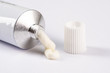 ointment or cream for external use is slightly squeezed out of a tube on a white background on a white background