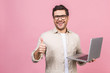 © denis_vermenko - Young business man wearing glasses working using computer laptop with a smile isolated over pink background.