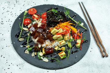 Wall Mural - Hawaiian salmon fish poke bowl with rice, radish,cucumber, tomato, sesame seeds and seaweeds. Buddha bowl. Diet food