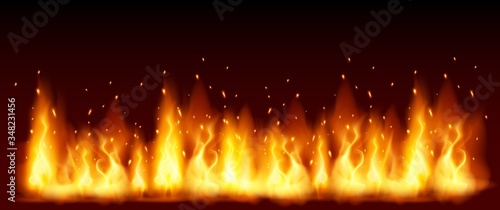 Cuadros en Lienzo Burning red hot sparks fly from large fire in the night sky