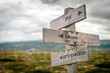 © Jon Anders Wiken - be more stoked text engraved on old wooden signpost outdoors in nature. Quotes, words and illustration concept.