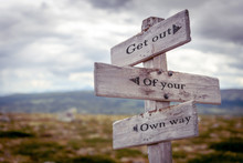 Get Out Of Your Own Way Text Engraved On Old Wooden Signpost Outdoors In Nature. Quotes, Words And Illustration Concept.