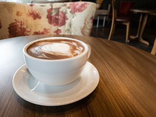 white cup of hot cocoa chocolate drink on wood table