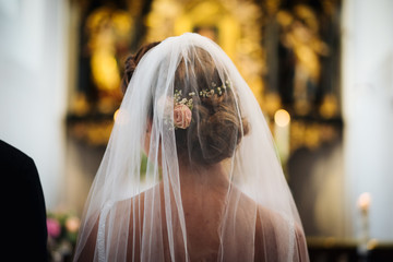 Wall Mural - photo of a bride wearing a veil in the church