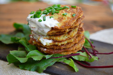 Wall Mural - potato patties stacked with fresh herbs.